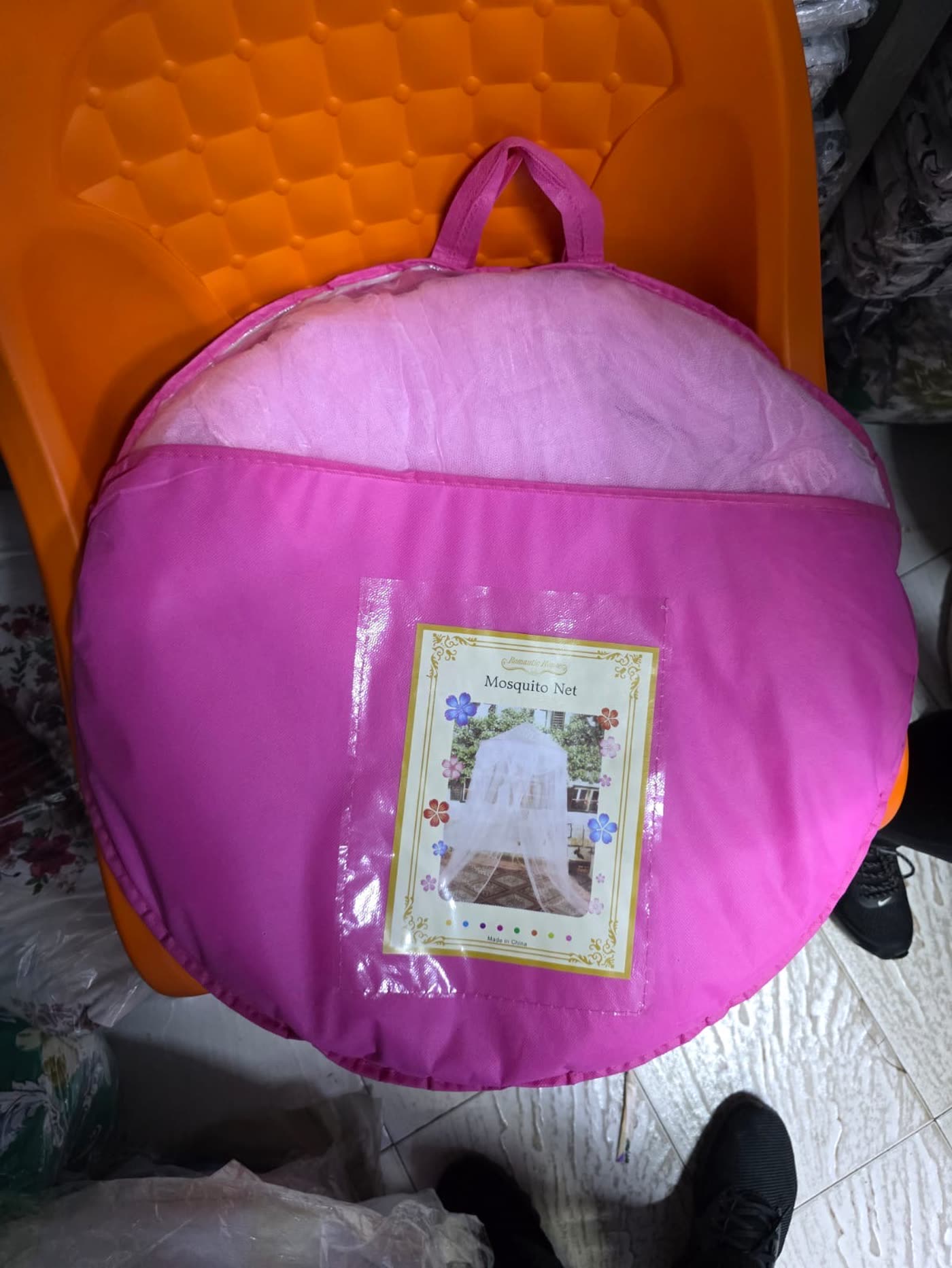 Pink mosquito net, packaged