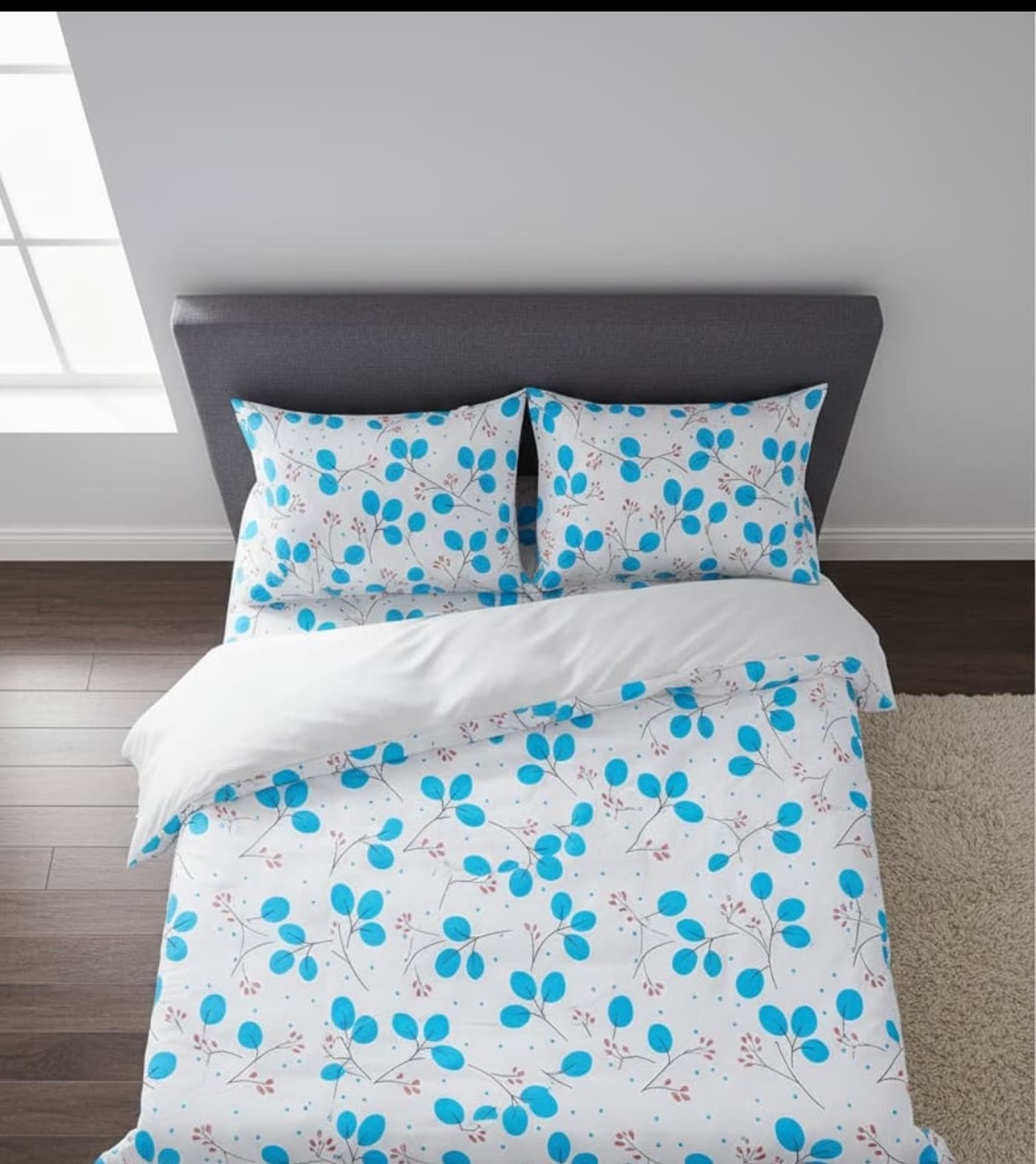 Bedding set in the blue leaf print, styled in a bedroom